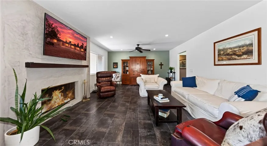 Front family room with fireplace. Flooring is ceramic tile.