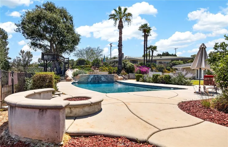 view of pool off side of gazebo.  Fire pit is gas.