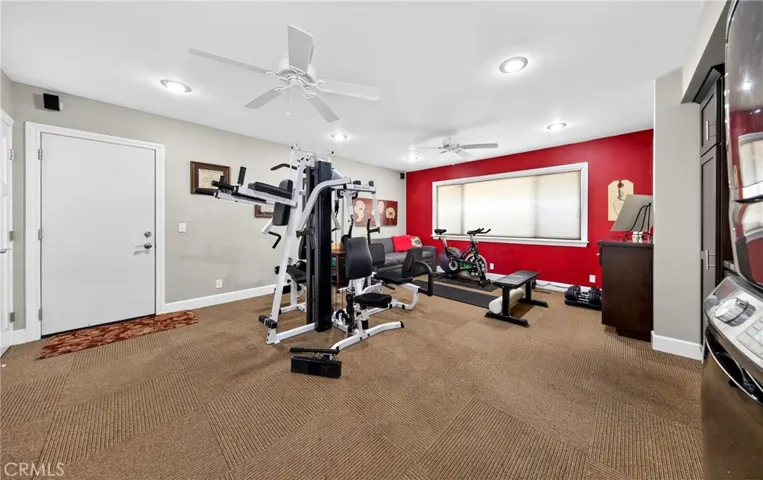 Extra room that is being used as a gym.  Has washer and dryer that will be left with the home.  This is on the same side as the house as the guest bedroom and bathroom.  Door goes to the garage.