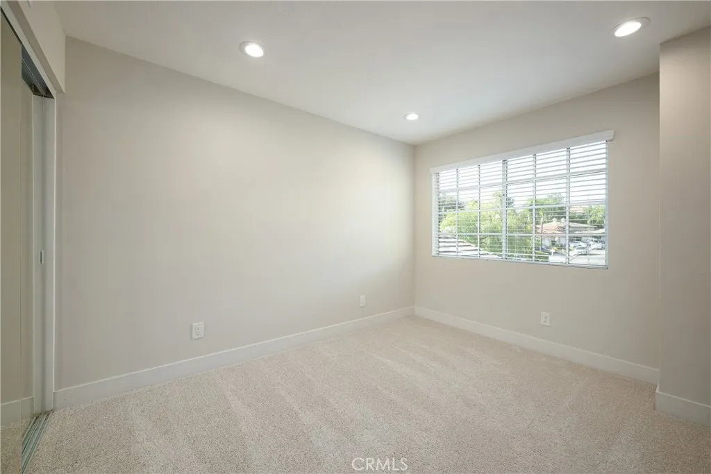 Additional guest bedroom with recessed lighting located upstairs.