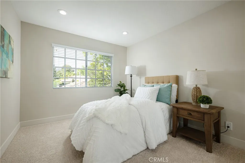 Guest bedroom with recessed lighting located upstairs.