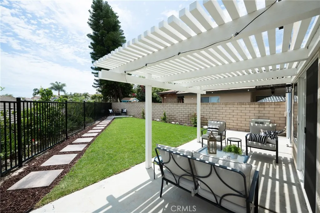 The large backyard and spacious side yard feature a covered patio, offering plenty of room for entertaining, relaxing, and outdoor dining.
