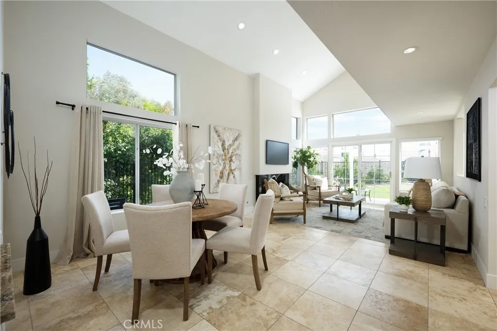 Welcome to this beautifully updated home featuring a welcoming living room with a vaulted ceiling and an abundance of windows that fill the space with natural light.