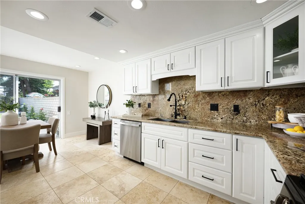 There are beautiful granite countertops in the kitchen and a breakfast nook.