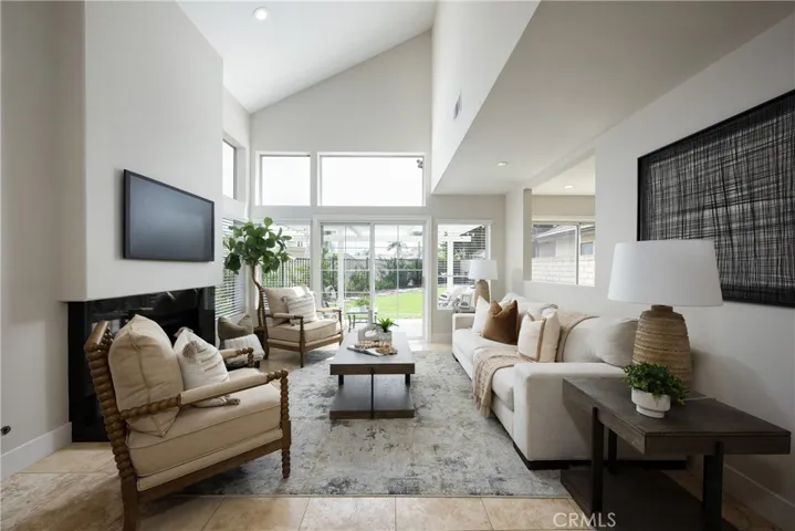 The living room features sliding doors and windows that look onto the backyard.