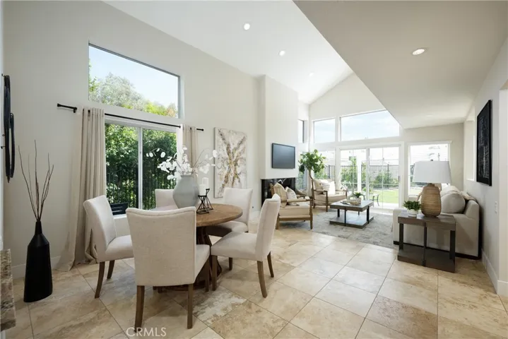 Welcome to this beautifully updated home featuring a welcoming living room with a vaulted ceiling and an abundance of windows that fill the space with natural light.