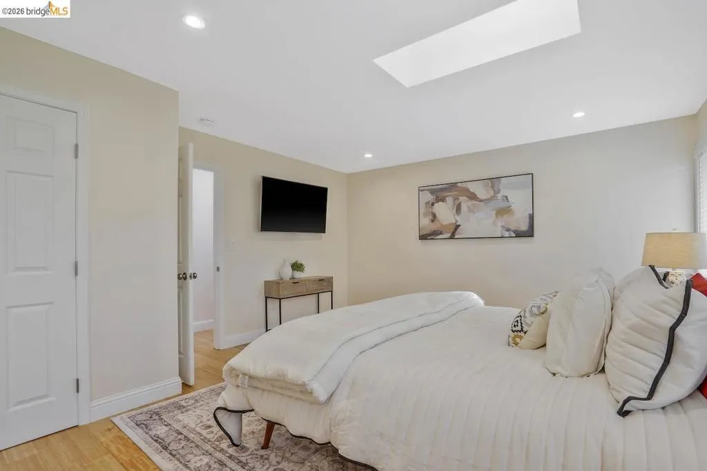 Recessed lighting illuminates this space, complemented by a rectangular skylight