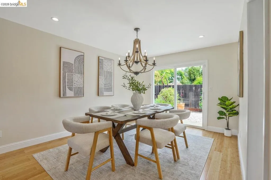 Dining area with wood-finish flooring, recessed lighting, and a sliding glass door leading to the exterior
