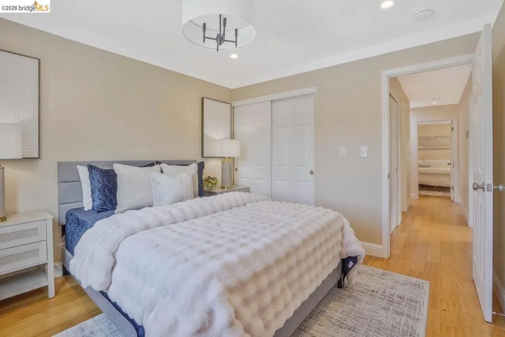 Bedroom featuring light wood-finish flooring, recessed lighting, and a modern drum chandelier