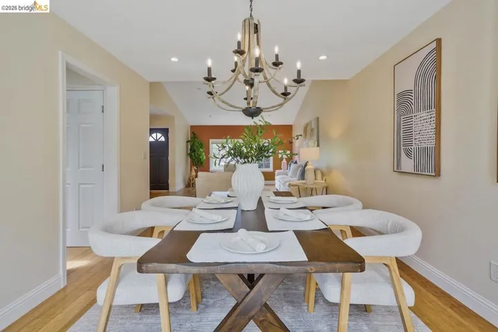 Dining area featuring a rustic-style chandelier and wood-finish flooring