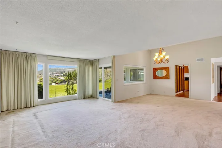 Picture window with a view of the hillside. Access to the Patio.