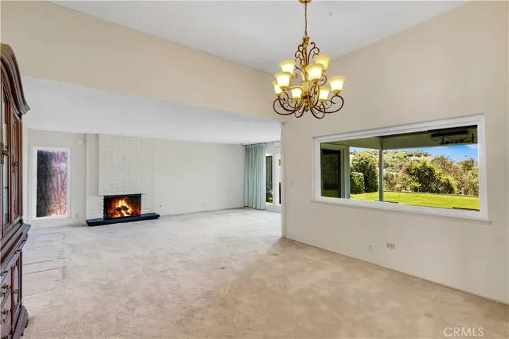 Formal dining room open to the living room and cozy fireplace.