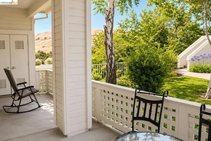 Covered patio featuring concrete flooring and white slatted siding
