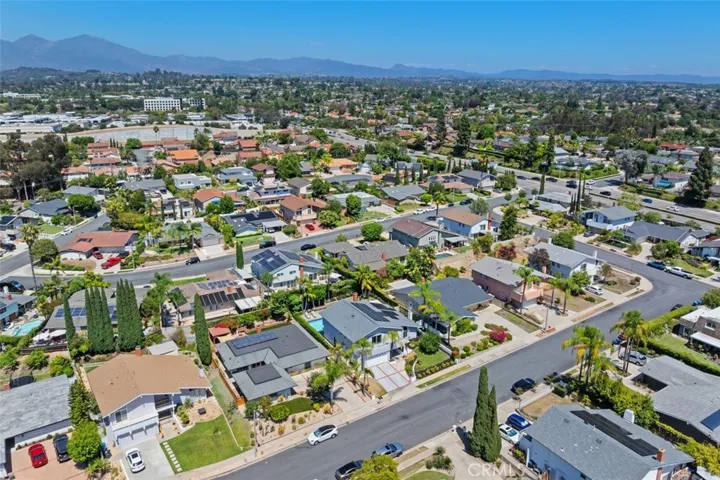 The aerial perspective perfectly showcases the clean exterior architecture, multi-car driveway, and beautifully manicured curb appeal of 22501 Classic Dr.