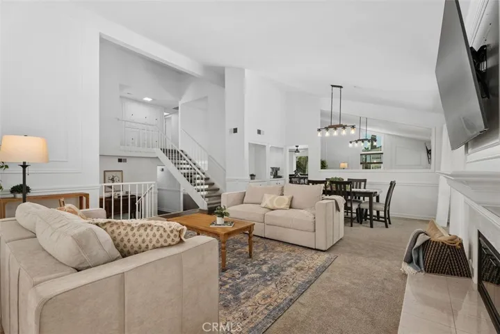 An open-concept layout effortlessly connects the spacious living room to the adjacent dining area, creating a perfect environment for seamless everyday living and entertaining.