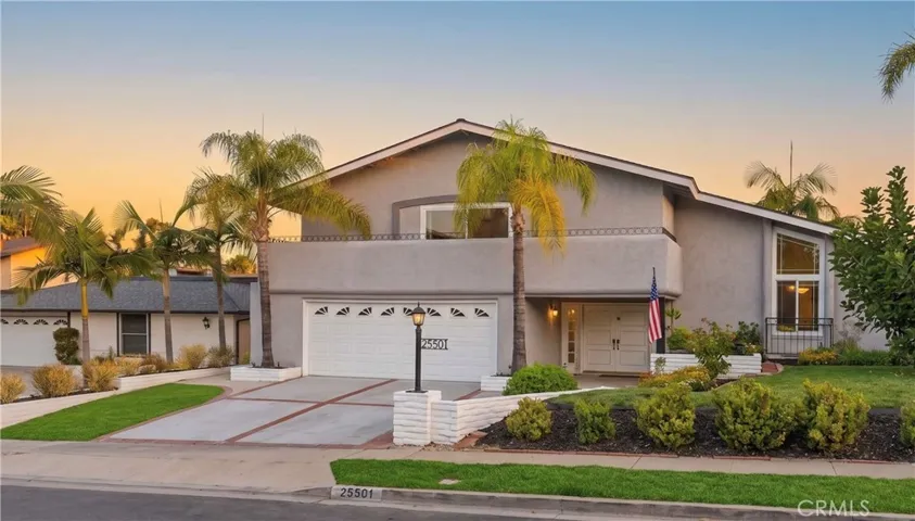 Welcome home! A beautifully manicured front lawn, mature palm trees, and a full driveway lead up to this stunning, split-level home, offering great curb appeal.

*The twilight background & parts of the grass have been digitally enhanced.*