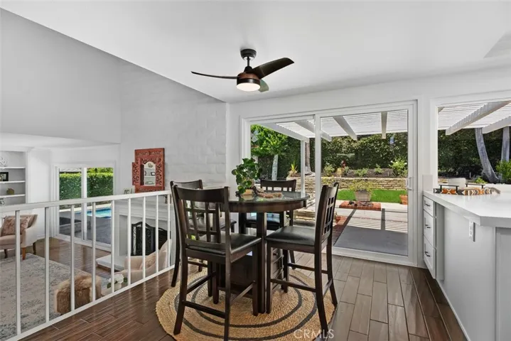 Perfect positioned between the kitchen and family room, this casual dining area features engineered hardwood flooring, a sleek modern ceiling fan, and sliding doors to the backyard patio.