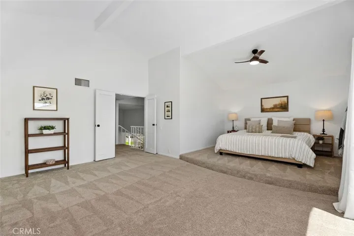Boasting an abundance of space, the primary bedroom includes a versatile sitting area with custom built-ins, perfect for a media setup or reading nook.