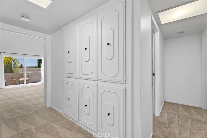 The upper landing provides excellent utility with built-in floor-to-ceiling linen cabinets and closets finished with elegant millwork.
