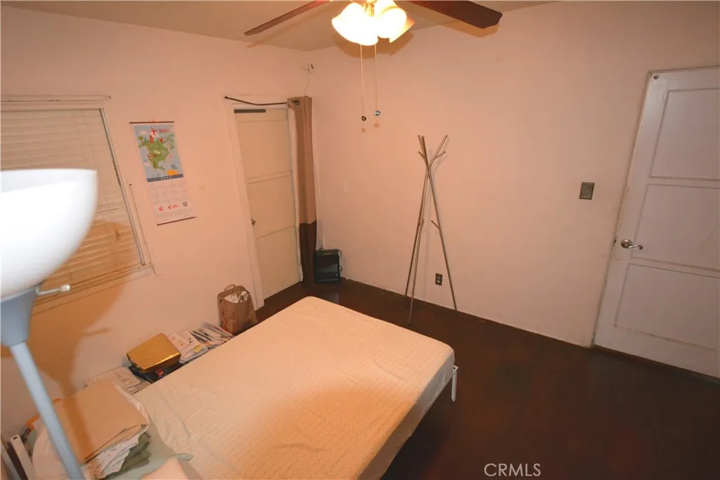 Another view of bedroom number one - note the ceiling fan, spacious closet and wood flooring.