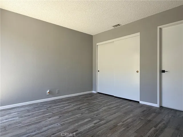 2nd bedroom or den with double door entry features direct access to bathroom and back patio.