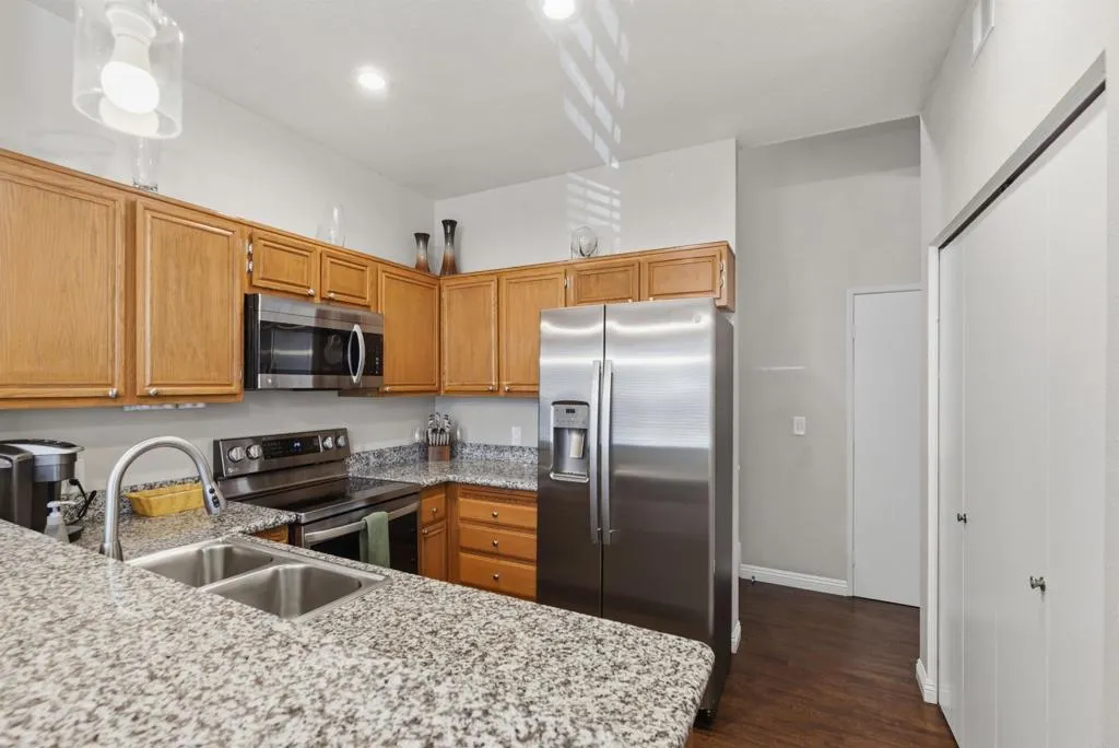 Opens to dining area and has newly refinished cabinetry, granite counters and stainless steel appl.