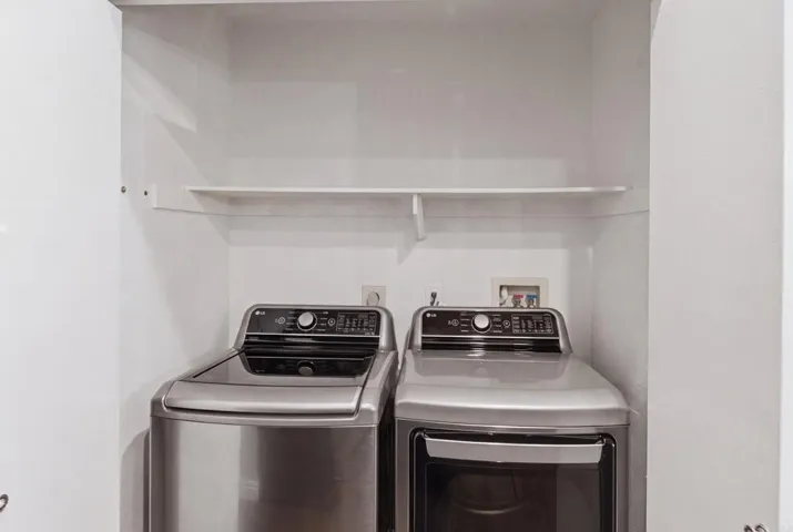 Beautiful full size side by side stainless washer/dryer.