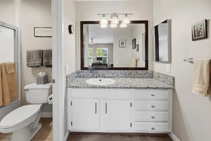 Both Primary Suite baths have granite countertops.