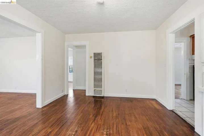 Hardwood-style flooring throughout the main room with a wall-mounted heating unit