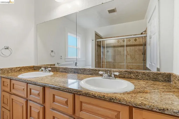 Double vanity featuring an expansive countertop with dual undermount sinks and chrome fixtures