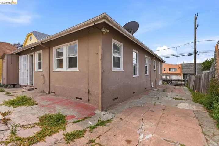 Rear exterior with stucco siding and white-framed windows