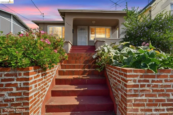 Stucco-fronted residence featuring a raised foundation and a covered entry