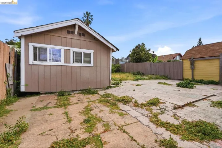 Detached structure with siding exterior and multiple windows