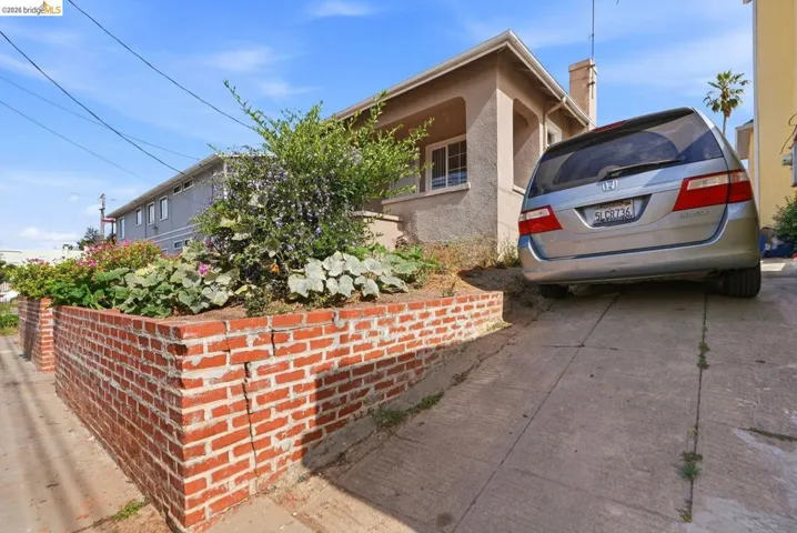 Raised brick planter box featuring mature plantings