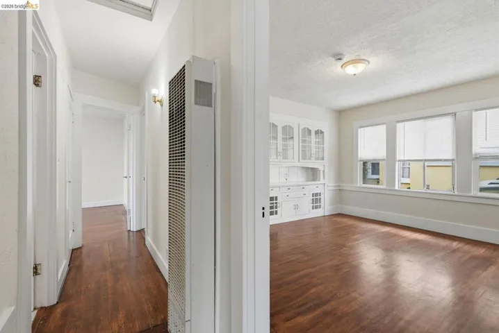 Hardwood flooring spanning the hallway and main room