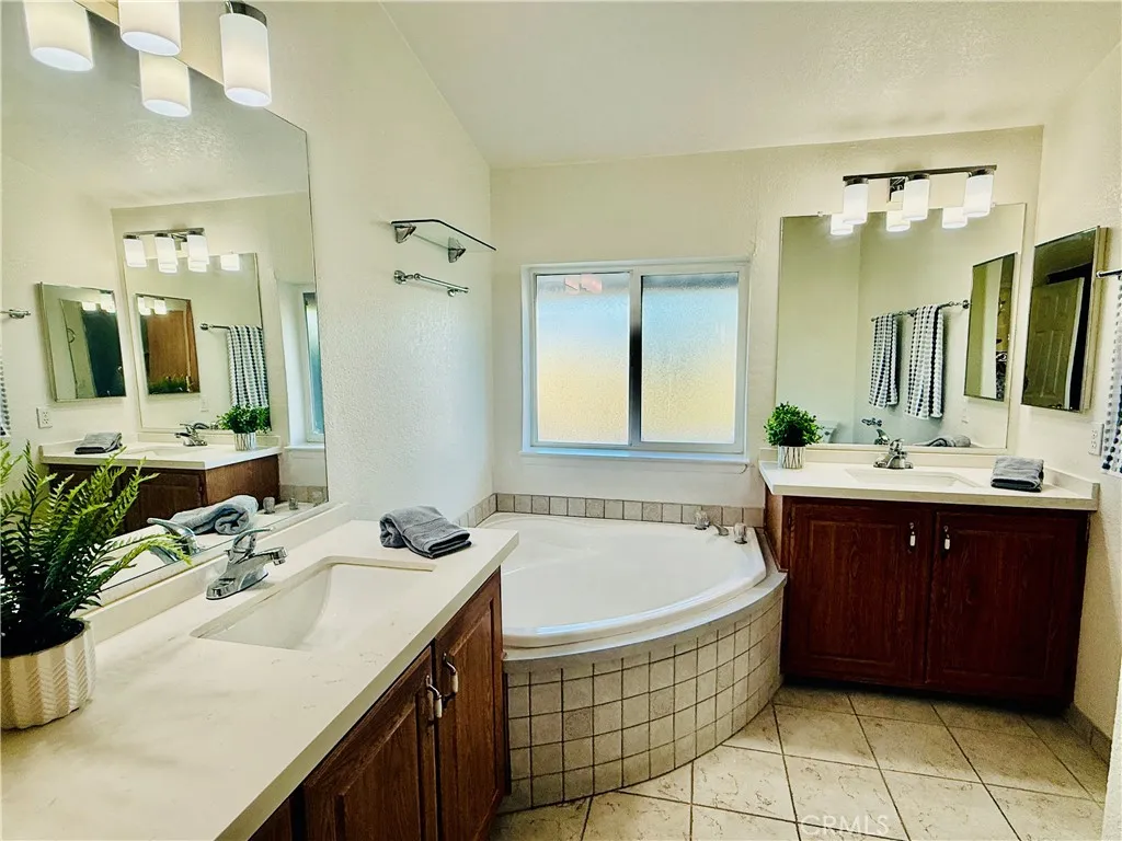 Primary bathroom with two sinks and a large soaking tub