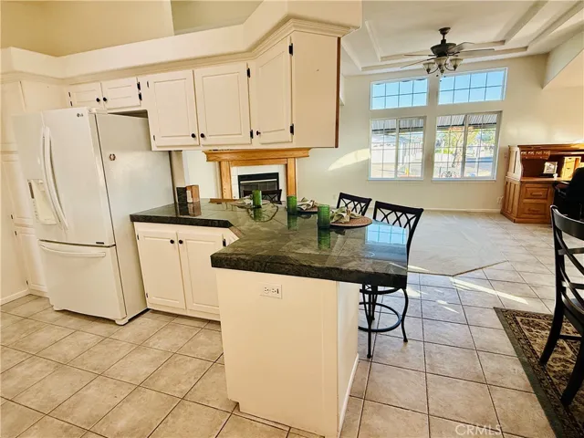 Kitchen area with modern white cabinets and black hardware.
