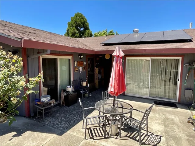 Ready for entertaining, back yard patio areas and deck nearby, and check out that nice roof, with a portion of the solar panels in view here, many more on the side not shown in the pictures