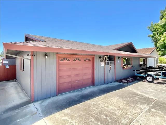 Side of home, showing garage, roof, driveway, with a lot of room for your boat trailers, trucks, cars and more