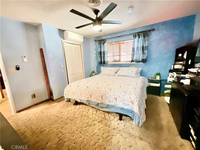 Primary Bedroom with ceiling fan and mini split
