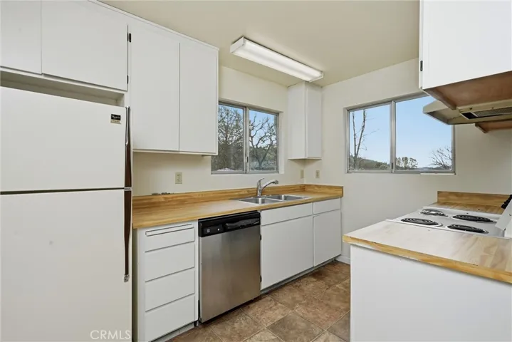 Efficient kitchen has lots of windows.