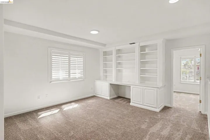Built-in white cabinetry with open shelving and lower storage