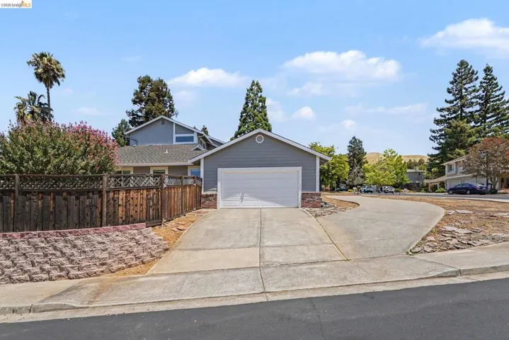 Gray siding exterior with a white garage door