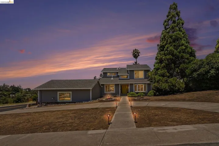 Contemporary residence featuring a split-level design and a prominent front entry with an accent door