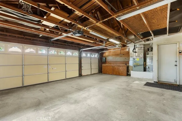 Large garage with work bench and storage on both sides