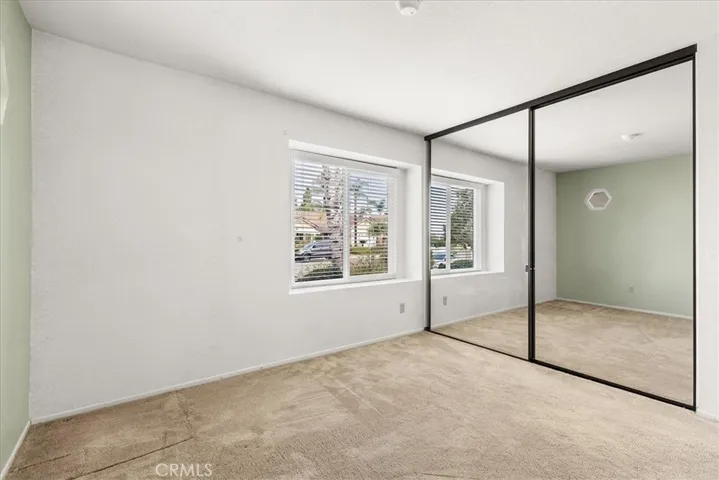 4th bedroom with mirrored closet doors