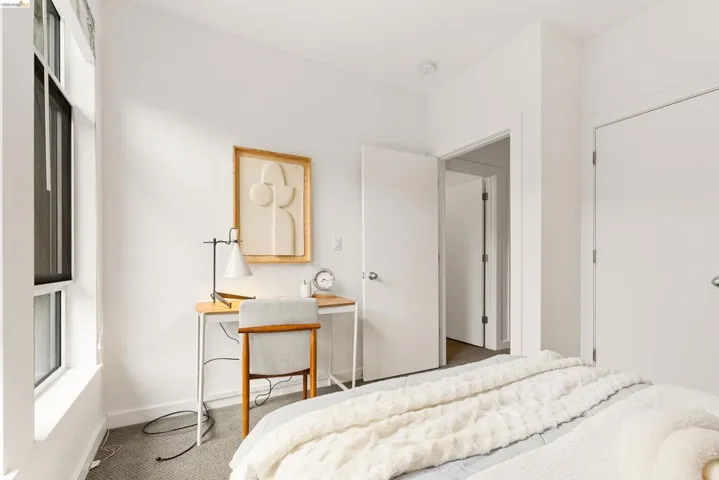 Room with recessed lighting, white walls, and a window featuring a white frame