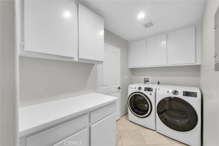 Inside enclosed laundry room with brand new washer and dryer