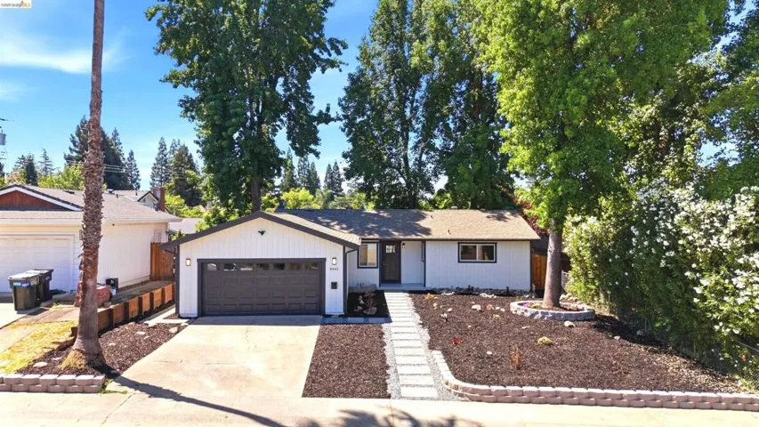 White exterior with dark trim and an attached two-car garage