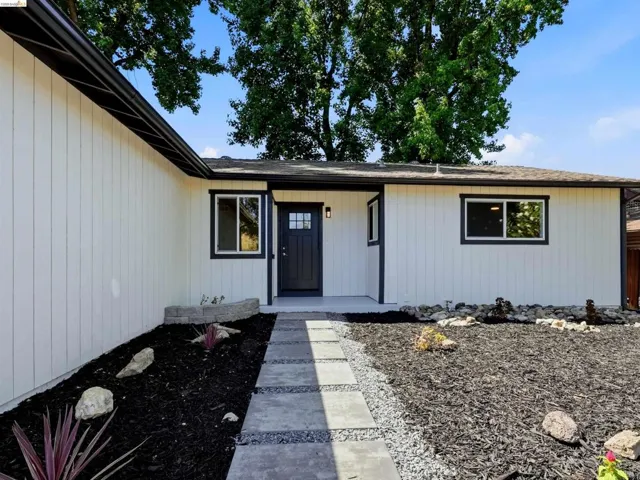 Clean white vertical siding exterior with dark trim accents
